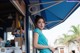 A woman standing in front of a blue awning.