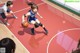 A woman dribbling a basketball on a basketball court.