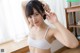 A woman in a white bra posing for a picture.
